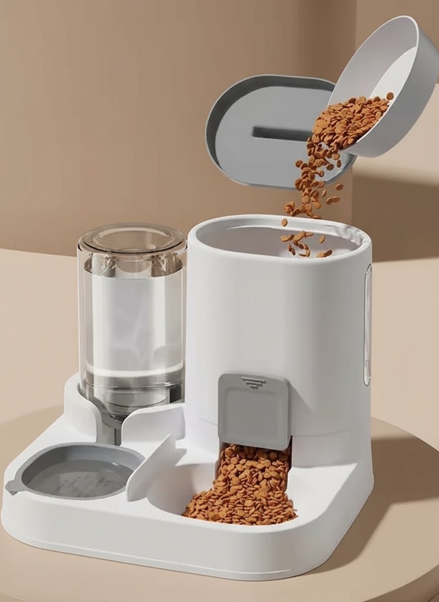 White pet feeder with water and food compartments on a gray background